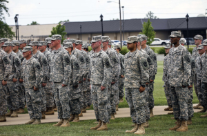 Soldiers from the Wisconsin and Utah Army National Guard and U.S. Army Reserve sing the Army song after donning the historic "Old Abe" patch ceremony at 101st Division Headquarters, at Fort Campbell, Ky., June 16, 2015. The 101st Airborne Division (Air Assault) became the first division headquarters to convert to a multi-component unit division headquarters. The purpose of multi-component unit division headquarters is to fully integrate Reserve and National Guard Soldiers into the modification table of organization and equipment.
